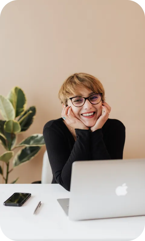 A smiling woman at a laptop